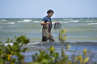 Student in the water holding equipment to conduct research
