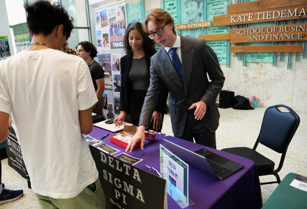 homas at a tabling event promoting Delta Sigma Pi at the Kate Tiedemann School of Business and Finance