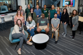 Group shot of fourteen library staff members