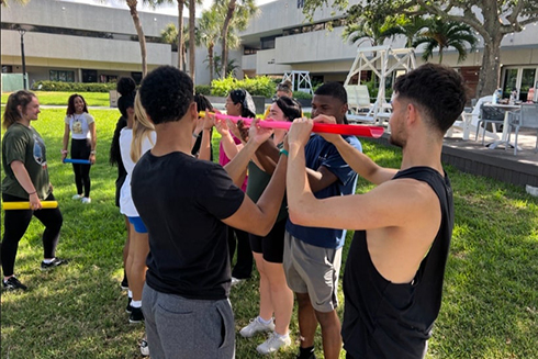 students performing a group challenge