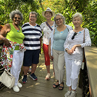 A group of OLLI members visiting a butterfly garden.