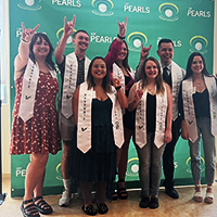 Students in the USF Pearls program during a graduate celebration ceremony.