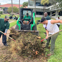 USF St. Petersburg facility team members clean up hurricane debris on campus.