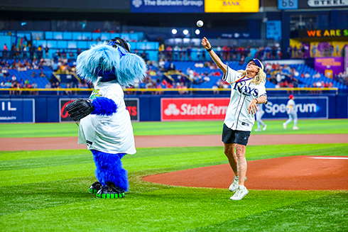 USF Sailing Coach Allison Jolly, an Olympic sailing gold medalist, threw the first pitch