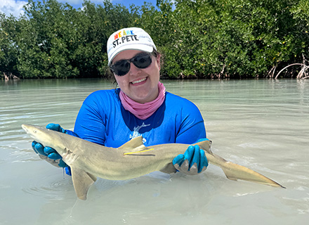 Reni Poston-Hymel holding a lemon shark. The research was conducted under ESA permit 22078 and ENP Permit SCI 0007.