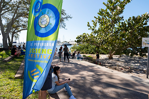 science fest banner with people around