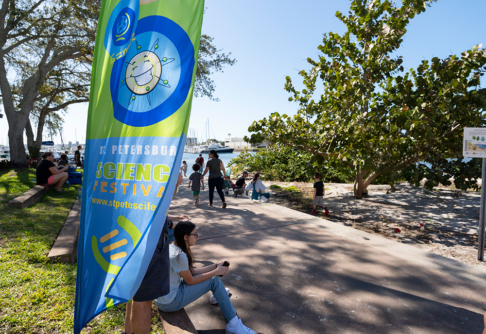 science fest banner with people around