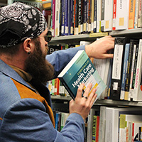 Jesse Roguska manages the course reserves for the Textbook Affordability Project at the Nelson Poynter Memorial Library.