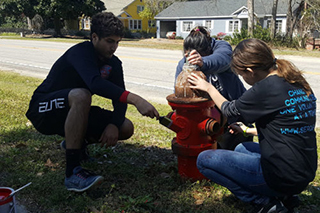 Students painting fire hydrants
